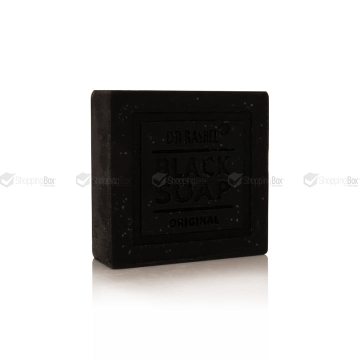 A rectangular bar of Dr. Bansi Black Soap Original, shown standing upright on a white reflective surface against a white background.