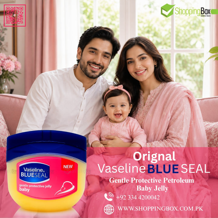 A family of three is sitting on a pink sofa in a bright living room, with a jar of Vaseline Blue Seal baby protective jelly prominently displayed in the lower left. The image includes a pink banner with product text and the ShoppingBox website.